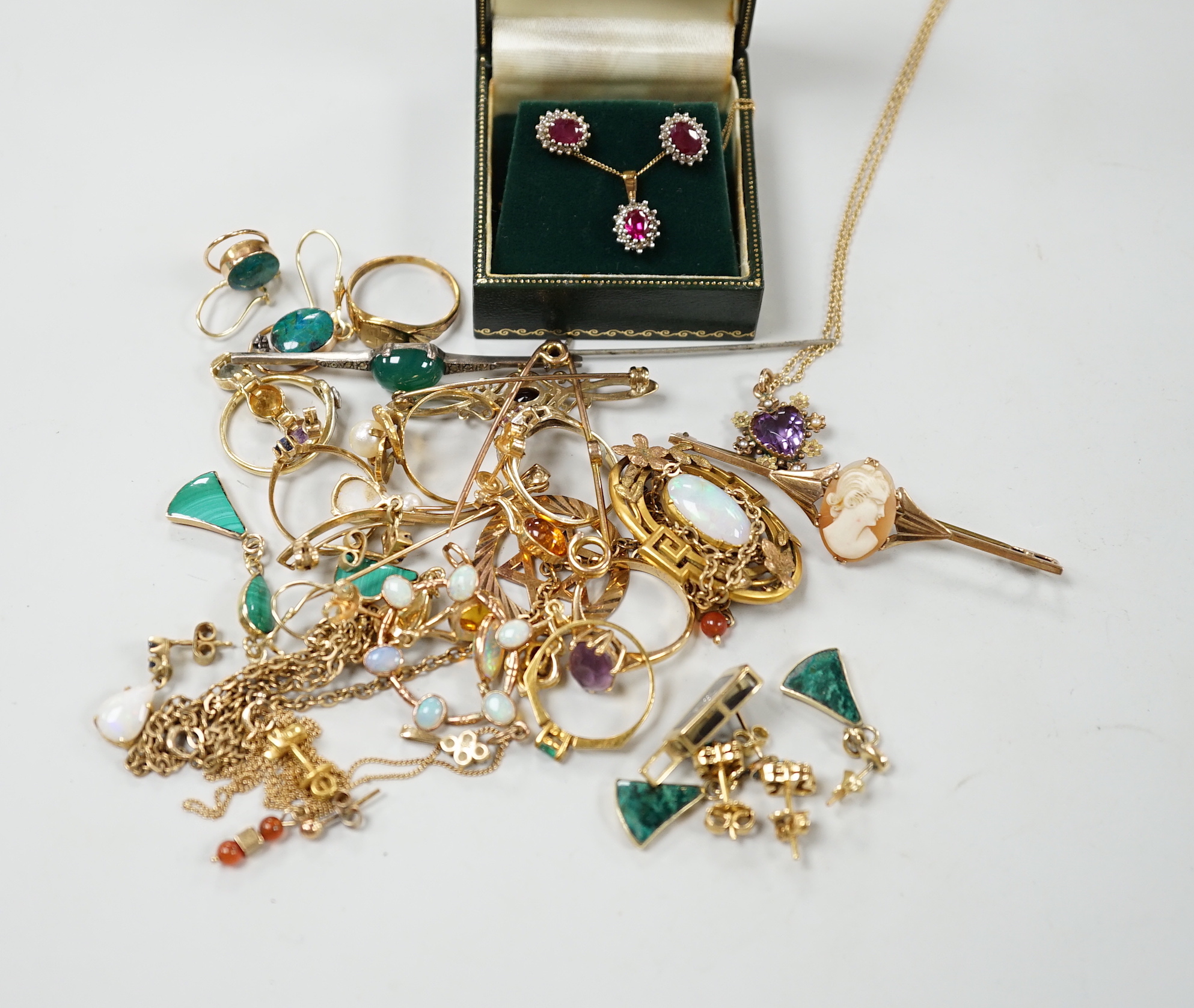 A group of assorted late Victorian and later jewellery including a 9ct gold, amethyst and seed pearl set heart shaped pendant necklace, a yellow metal and white opal cluster set pendant on a gold plated chain, a yellow m